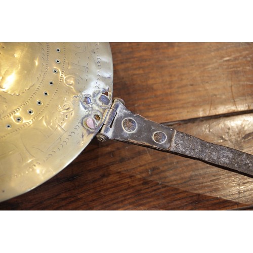 394 - A mid 17th century iron and brass warming pan, the tapering flat iron handle extending to a circular... 