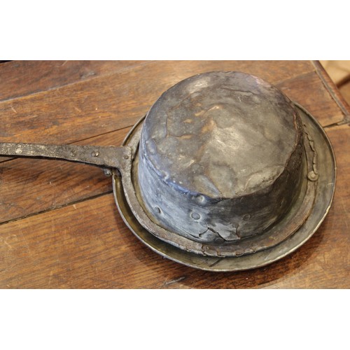 394 - A mid 17th century iron and brass warming pan, the tapering flat iron handle extending to a circular... 