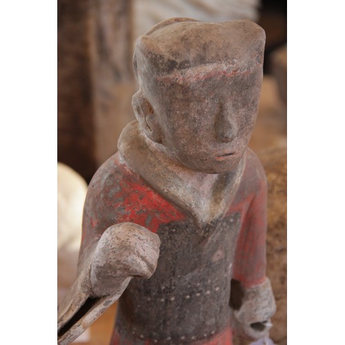 321 - A Chinese pottery warrior, possibly Han dynasty, modelled standing wearing armour and painted in bla... 