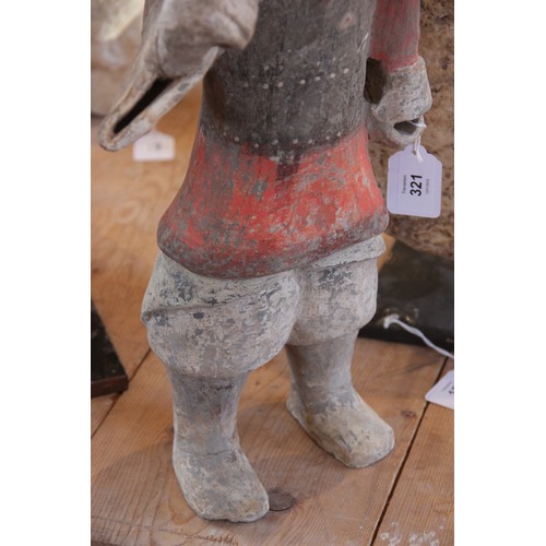 321 - A Chinese pottery warrior, possibly Han dynasty, modelled standing wearing armour and painted in bla... 