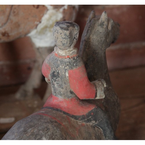 334 - A Chinese pottery model of a figure riding a horse, possibly Han dynasty, the horse standing on four... 