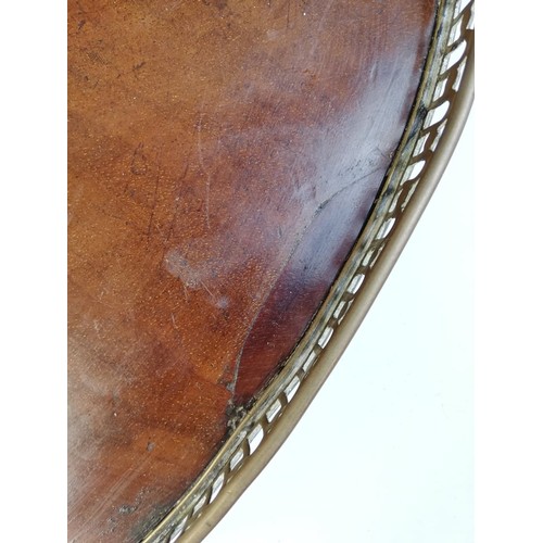 589 - A George III inlaid mahogany oval tray, with a pierced brass gallery and brass side handles, inlaid ... 