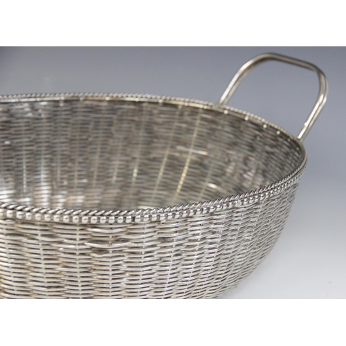 118 - A Christofle silver plated bread bowl, in the form of a circular weaved basket with loop handle, 29c... 