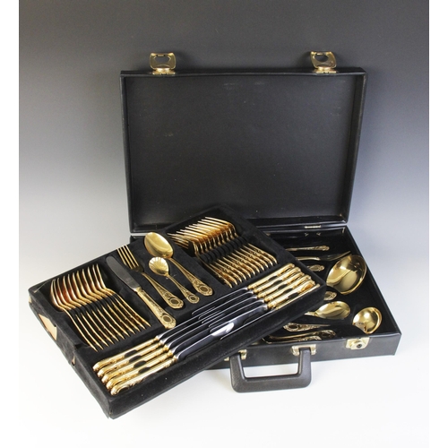 122 - A seventy-piece 23/24 Hartvergoldet gold plated canteen, twelve-place settings, complete in a black ... 