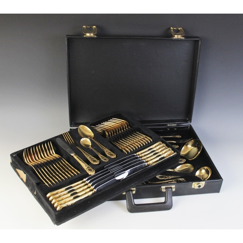 122 - A seventy-piece 23/24 Hartvergoldet gold plated canteen, twelve-place settings, complete in a black ... 