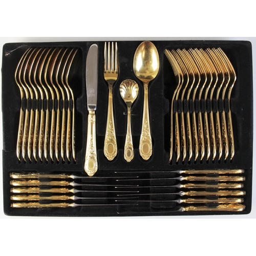 122 - A seventy-piece 23/24 Hartvergoldet gold plated canteen, twelve-place settings, complete in a black ... 