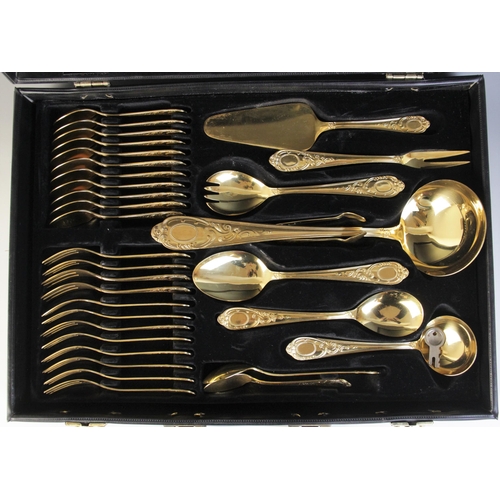 122 - A seventy-piece 23/24 Hartvergoldet gold plated canteen, twelve-place settings, complete in a black ... 