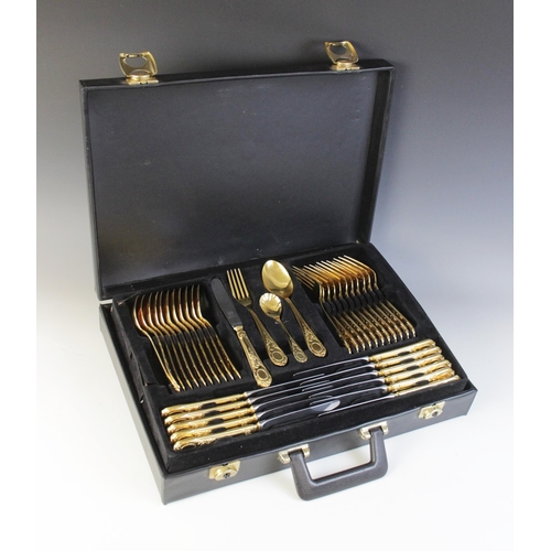 122 - A seventy-piece 23/24 Hartvergoldet gold plated canteen, twelve-place settings, complete in a black ... 