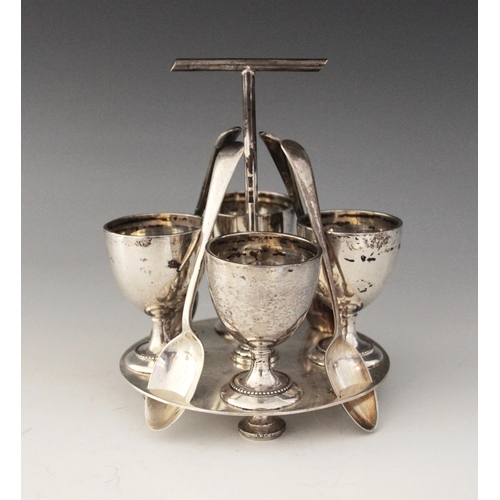 38 - A George V silver egg cruet, Mappin & Webb, Sheffield 1911, comprising four cups, each 6.2cm high, s... 