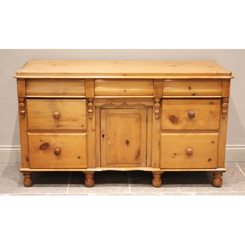 693 - A Victorian pine and later dresser base, the slab top with rounded front corners above three cushion... 