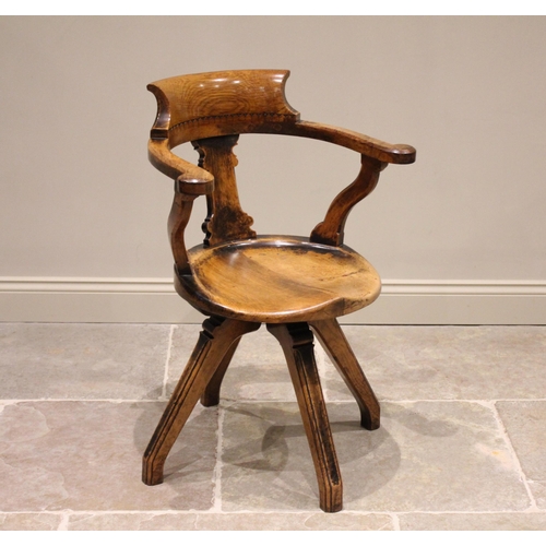 694 - A late Victorian oak and pollard oak Aesthetic Movement revolving office desk chair, the pollard oak... 