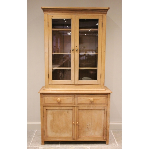 696 - A Victorian pine glazed kitchen cupboard, the moulded cornice above a pair of glazed doors opening t... 