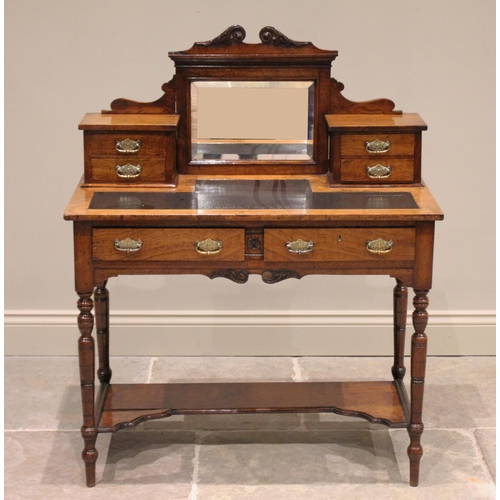 698 - A Victorian burr oak ladies writing desk, the raised back with a central mirror flanked by two banks... 