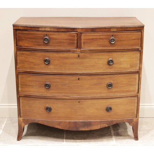 699 - An early 19th century bowfront mahogany chest of drawers, the chest top with a reeded edge and inlai... 