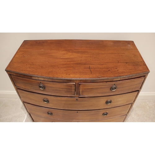 699 - An early 19th century bowfront mahogany chest of drawers, the chest top with a reeded edge and inlai... 