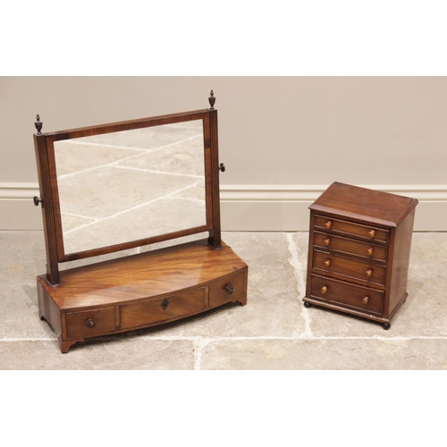 700 - A George III mahogany dressing table mirror, the rectangular mirror on reeded supports, upon a bowfr... 