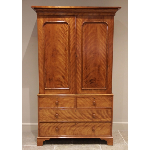 704 - A Victorian satin birch linen press, finished with a tiger stripe patina, the moulded cornice above ... 