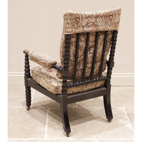 705 - A 19th century ebonised bobbin turned armchair, with later padded back rest and arm rests, the bobbi... 