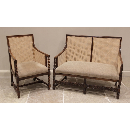 729 - A 1920's stained beech wood bergere two seater settee, the rattan side and back panels enclosing a t... 