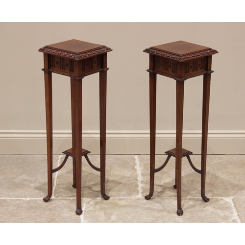 730 - A pair of mahogany plant stands, early 20th century, each with a square top and carved border above ... 