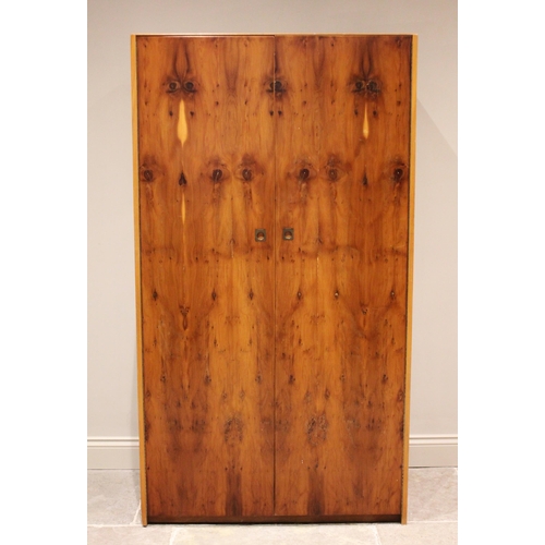 731 - A mid century 'Heals Furniture' yew wardrobe, the twin doors with full height hinges, inset with bra... 