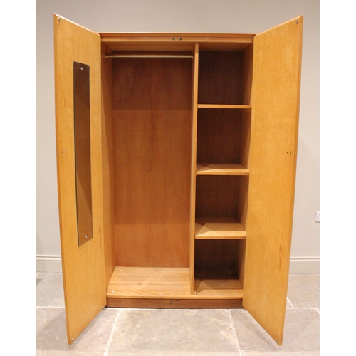 731 - A mid century 'Heals Furniture' yew wardrobe, the twin doors with full height hinges, inset with bra... 