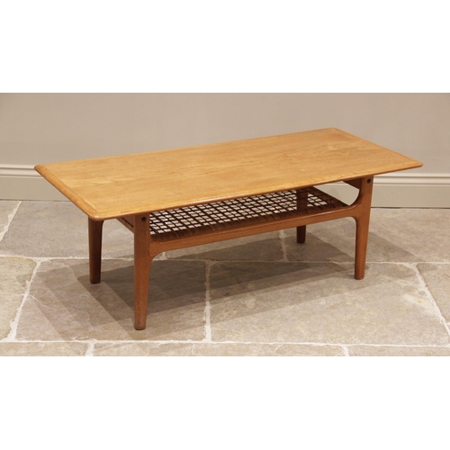 734 - A 1960's/70's Danish teak coffee table by Trioh, the rectangular moulded top raised upon legs of tap... 