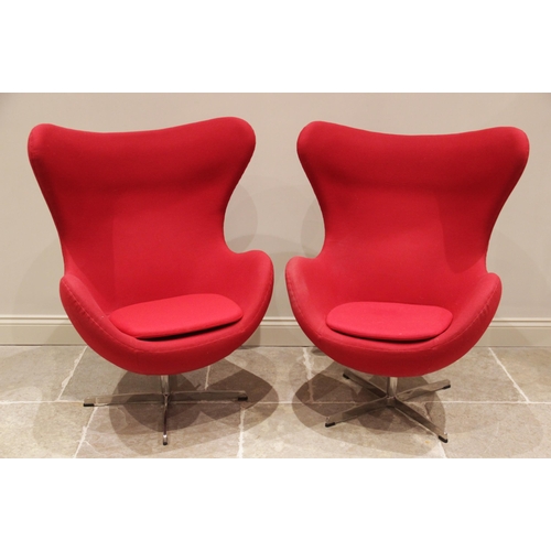 735 - A pair of 1960's egg shaped revolving office chairs in the style of Arne Jacobsen for Fritz Hansen, ... 