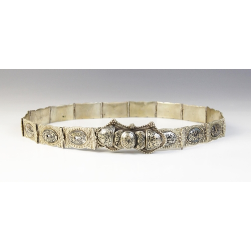 85 - An Armenian silver coloured niello belt, each link designed as an oval panel decorated in niello wit... 