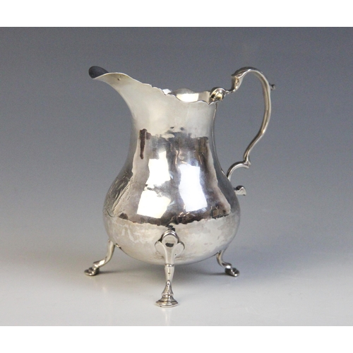 91 - A George III silver cream jug, London 1763 (maker's marks worn), of baluster form with foliate cappe... 