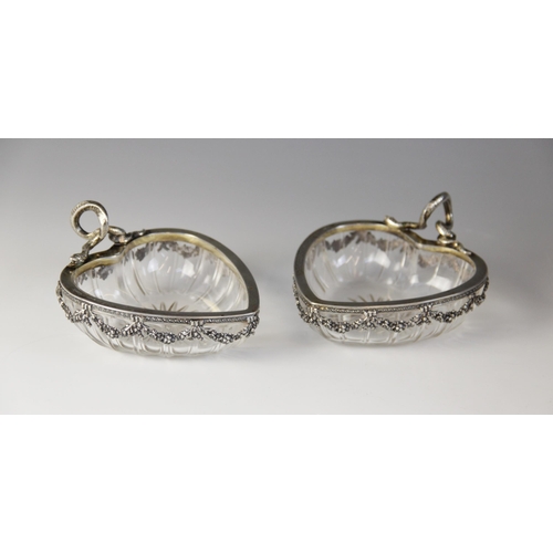 56 - A pair of late 19th century German silver mounted cut glass bon-bon dishes, the heart-shaped glass b... 