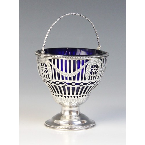 23 - A George III silver swing handled sugar basket, Thomas Heming, London 1774, of tapering form with pi... 