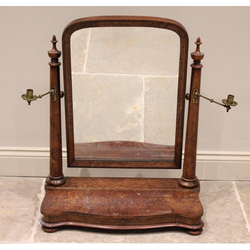 713 - A mid 19th century burr walnut toilet mirror, the arched mirror raised upon tapering cylindrical col... 