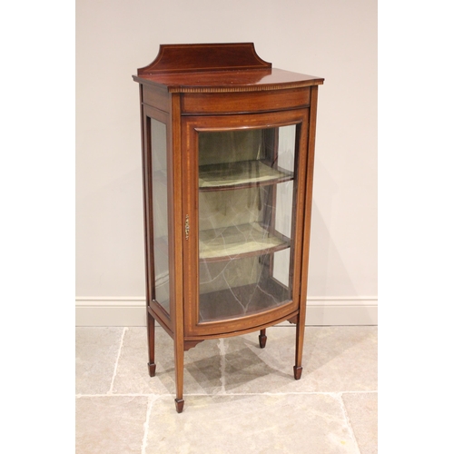 718 - An Edwardian mahogany bow front display cabinet, by Ray and Miles, Liverpool, the raised back above ... 