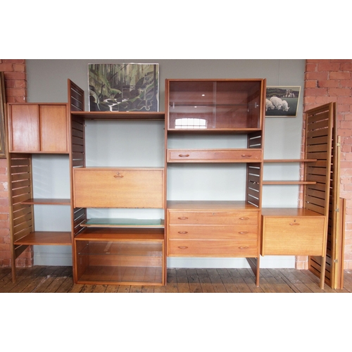 746 - A 1960's/70's Staples teak Ladderax wall unit, comprising; seven ladder racks, two glazed cabinets, ... 