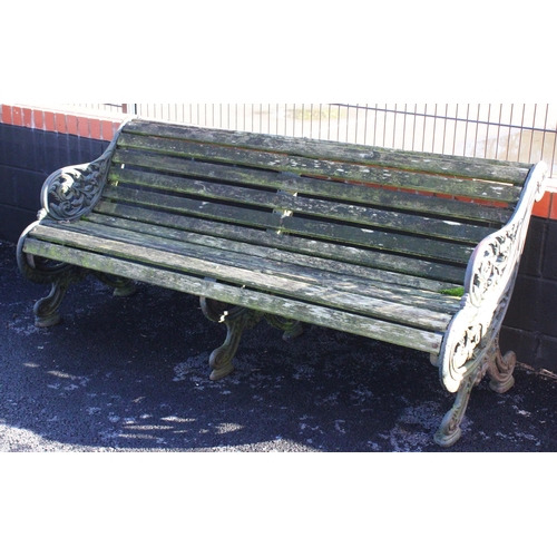 748 - A 19th century cast iron and slatted garden bench, with three cast supports, the swept foliate openw... 