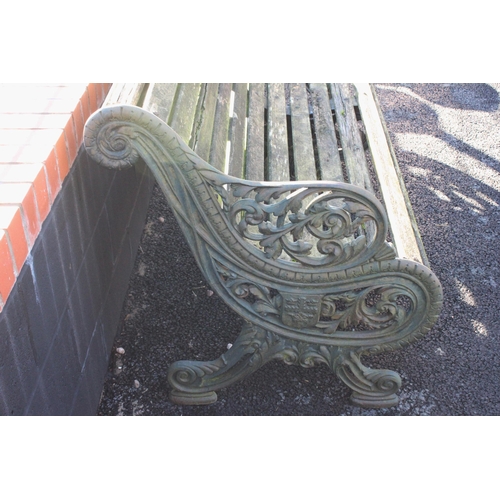 748 - A 19th century cast iron and slatted garden bench, with three cast supports, the swept foliate openw... 