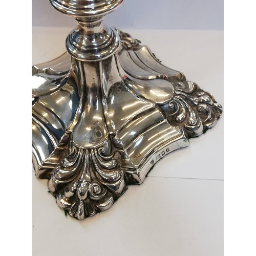 66 - A pair of George V silver mounted candlesticks, Ellis Jacob Greenberg, London 1926, each on shaped w... 