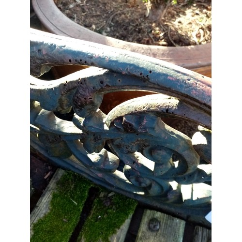 748 - A 19th century cast iron and slatted garden bench, with three cast supports, the swept foliate openw... 