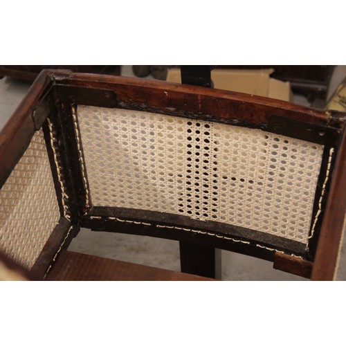 709 - A Victorian mahogany and rattan cradle, the ogee shaped canopy with turned finials above rattan side... 