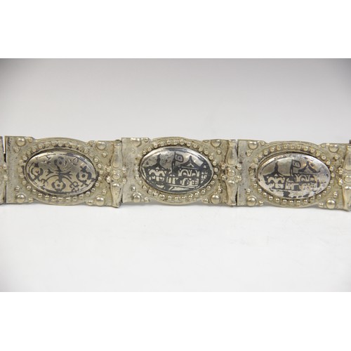 85 - An Armenian silver coloured niello belt, each link designed as an oval panel decorated in niello wit... 