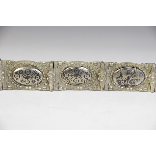 85 - An Armenian silver coloured niello belt, each link designed as an oval panel decorated in niello wit... 