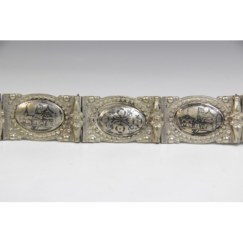 85 - An Armenian silver coloured niello belt, each link designed as an oval panel decorated in niello wit... 