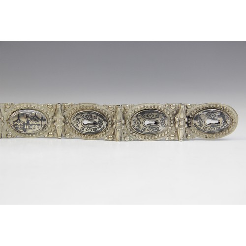 85 - An Armenian silver coloured niello belt, each link designed as an oval panel decorated in niello wit... 