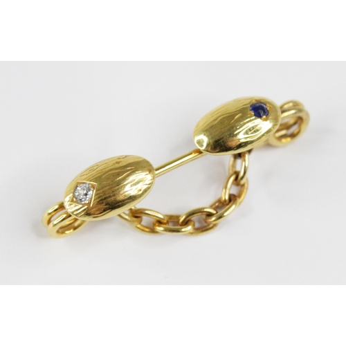 109 - A Victorian diamond and sapphire brooch, probably converted from a cufflink, designed as two oval pa... 