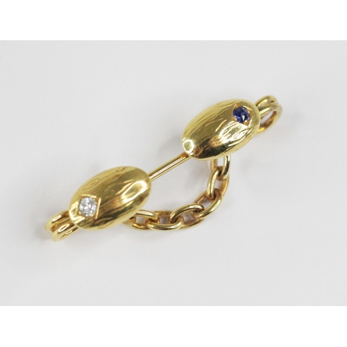 109 - A Victorian diamond and sapphire brooch, probably converted from a cufflink, designed as two oval pa... 