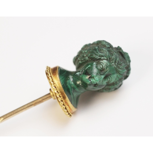 116 - A malachite stick pin, carved in the classical style as a female head with waved hair and a crown of... 