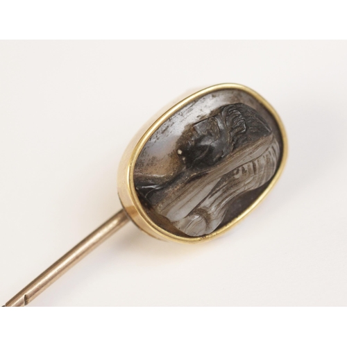 117 - A 19th century carved hardstone cameo set stick pin, the oval shaped cameo carved with the profile o... 