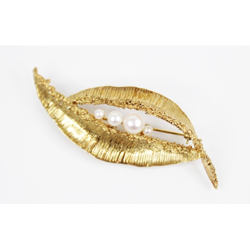 120 - A 1960's 9ct gold cultured pearl set brooch, of abstract form with textured detail, four round gradu... 