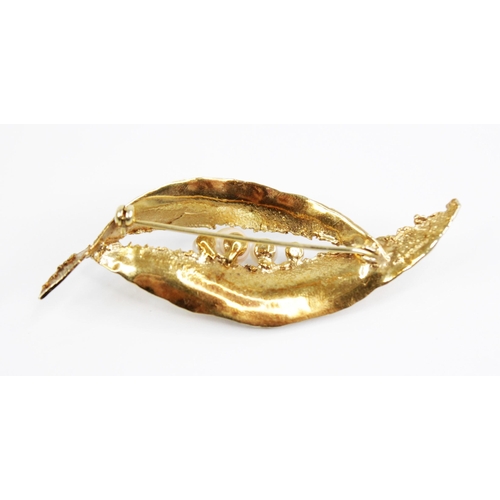 120 - A 1960's 9ct gold cultured pearl set brooch, of abstract form with textured detail, four round gradu... 